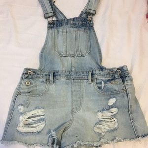 Light washed jean overalls.